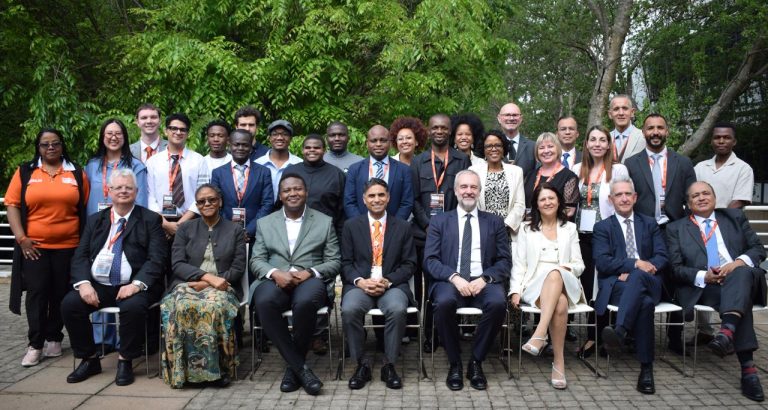 Conference participants gathered for a group photograph outdoors in Johannesburg.