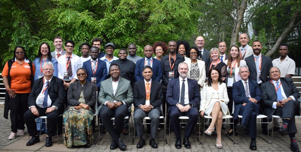 Conference participants gathered for a group photograph outdoors in Johannesburg.